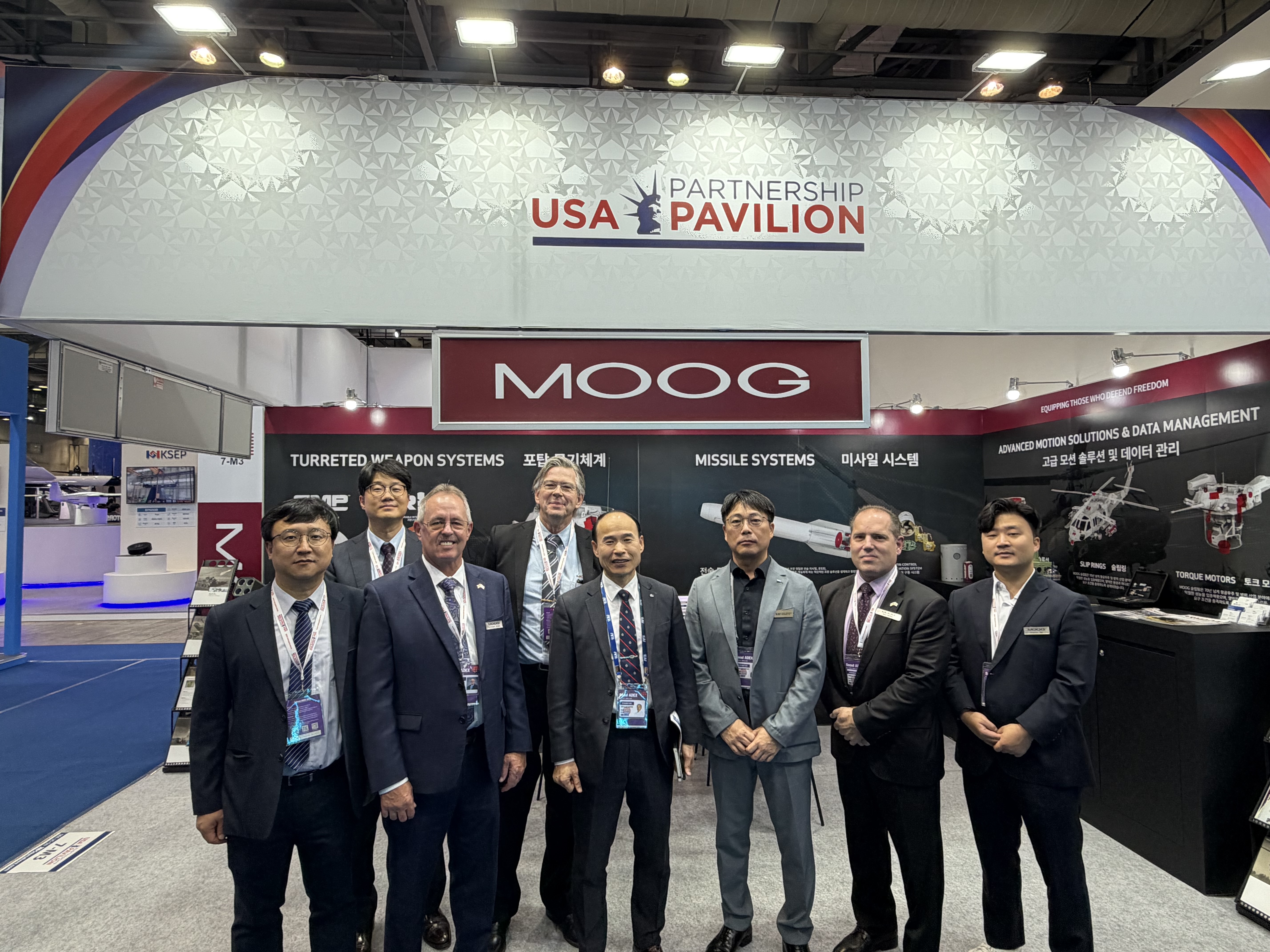 Team photo at the Moog booth during a defense exhibition at KINTEX, Korea